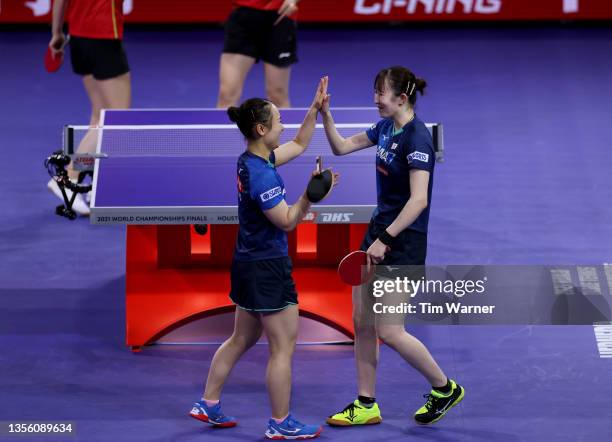 Mima Ito congratulates Hina Hayata of Japan after defeating Qian Tianyi and Chen Meng of China during the women's doubles semifinals match of the...
