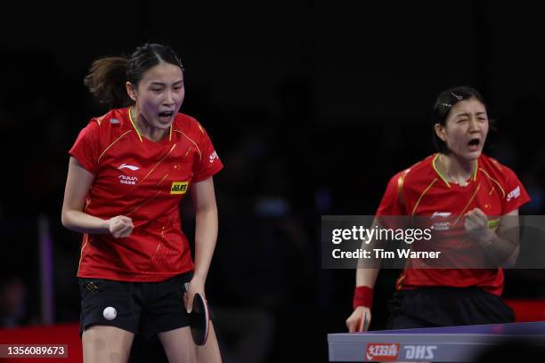 Qian Tianyi and Chen Meng of China react after a point against Hina Hayata and Mima Ito of Japan during the women's doubles semifinals match of the...