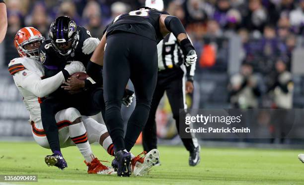 Lamar Jackson of the Baltimore Ravens is sacked by Myles Garrett of the Cleveland Browns in the first quarter during a game at M&T Bank Stadium on...