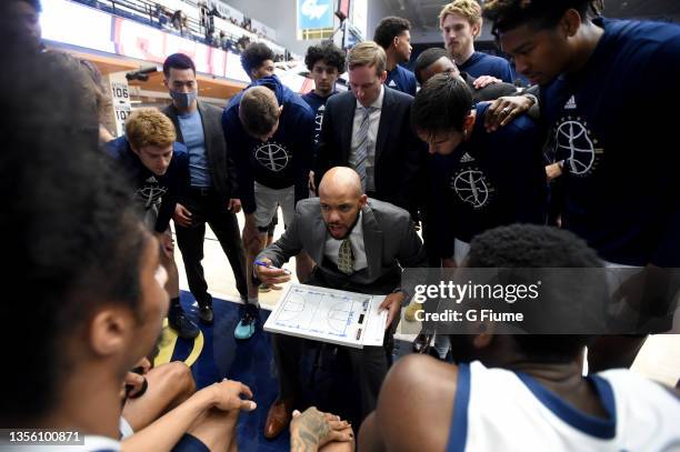 Head coach Jamion Christian of the George Washington Colonials talks to his team before the game against the St. Francis Red Flash at Charles E....