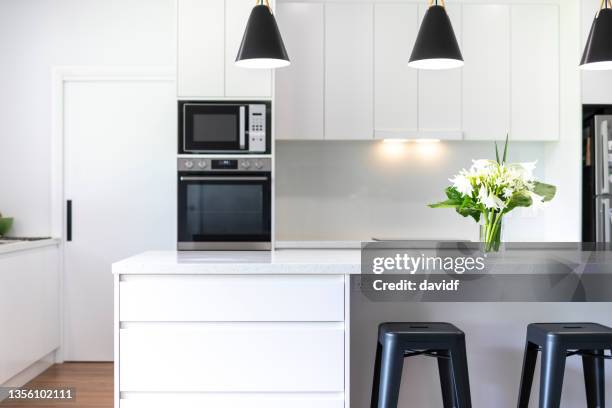 modern designer kitchen in a luxury home - clean kitchen stock pictures, royalty-free photos & images