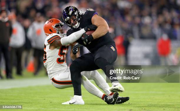 Anthony Levine Sr. #41 of the Baltimore Ravens is tackled by Malcolm Smith of the Cleveland Browns during a game at M&T Bank Stadium on November 28,...