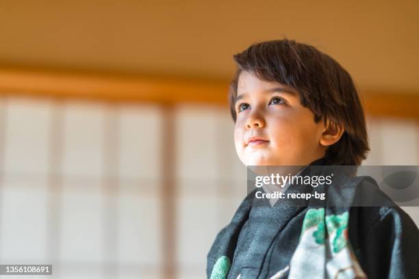 portrait of small multi-raced eurasian ethnic japanese boy dresses in japanese traditional clothing hakama for japanese traditional celebration called shichi go san - washitsu stock pictures, royalty-free photos & images