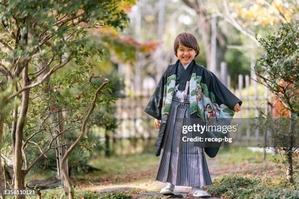portrait of small multi-raced eurasian ethnic japanese boy dresses in japanese traditional clothing hakama for japanese traditional celebration called shichi go san - shichi go san stock pictures, royalty-free photos & images