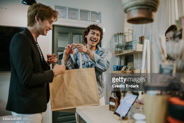 happy shopping day with asian lgbtqia people and his friend-stock photo - reusable bag stock pictures, royalty-free photos & images
