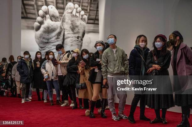 Visitors line up to see work by Italian artist Maurizio Cattelan that is part of his exhibition "The Last Judgement'' at the UCCA Center for...