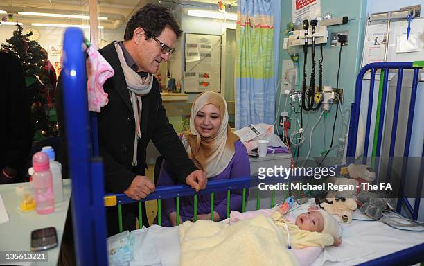 England manager Fabio Capello with patient Naima Essa on a visit to Great Ormond Street Hospital on December 12, 2011 in London, England.
