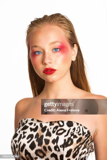 portrait of beautiful young woman with make-up dressing dress with tiger print - tiger girl stock pictures, royalty-free photos & images