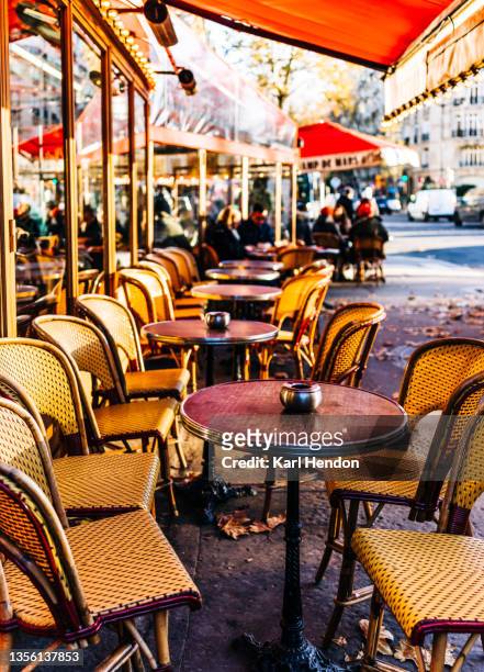 a daytime view of a paris cafe - stock photo - paris autumn stock pictures, royalty-free photos & images