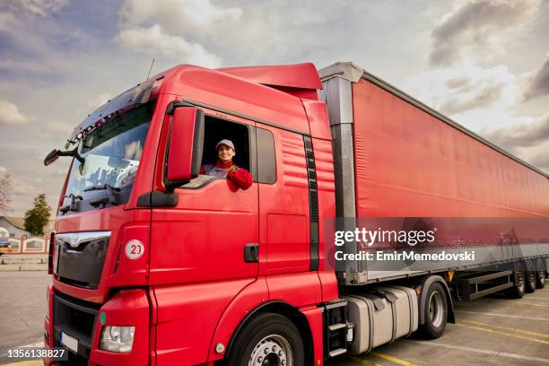 portrait of professional female truck driver smiling - trucking stock pictures, royalty-free photos & images