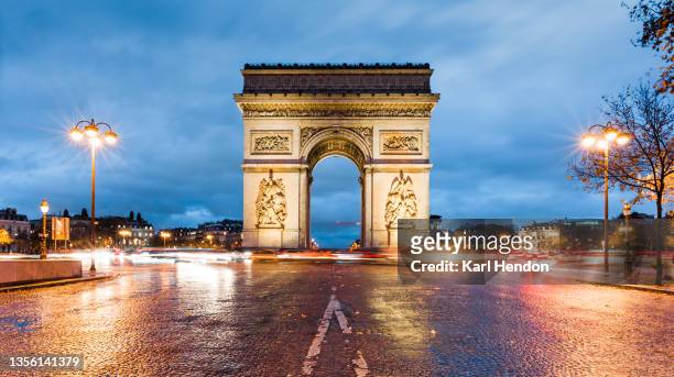 a night-time view of l'arc de triomphe in paris, france - stock photo - arc de triomphe parijs stockfoto's en -beelden