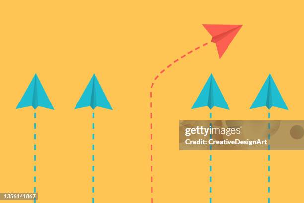 standing out from the crowd, think differently, individuality and leadership concept with paper airplanes. individual red paper plane flying in different direction. - freedom icon stock illustrations