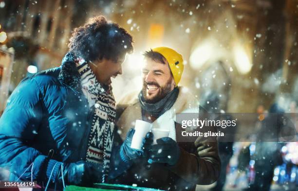 gay couple during christmas eve shopping. - christmas city stockfoto's en -beelden