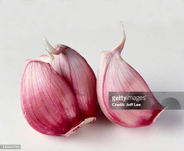 three garlic cloves - garlic stock pictures, royalty-free photos & images