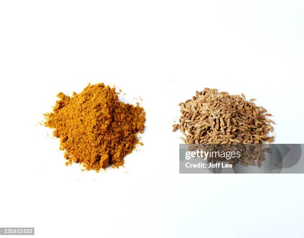 piles of cumin powder and cumin seeds - cumin stock pictures, royalty-free photos & images