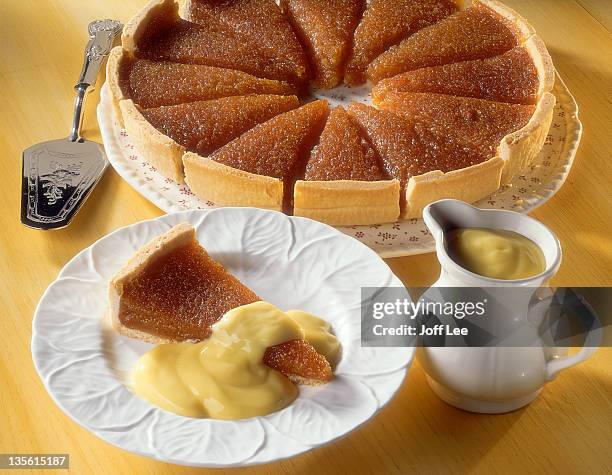 treacle tart with custard - molasses stock pictures, royalty-free photos & images