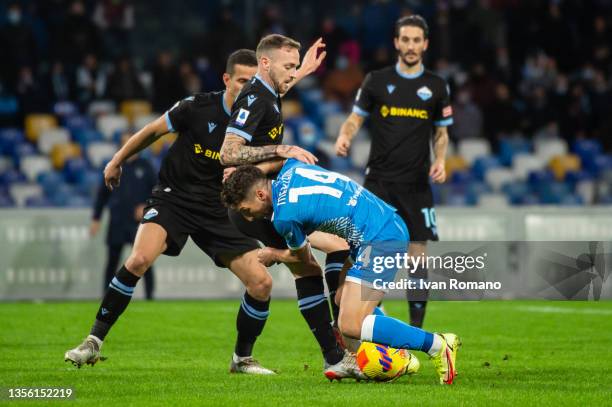 Dries Mertens of SSC Napoli and Manuel Lazzari of SS Lazio compete for the ball during the Serie A match between SSC Napoli and SS Lazio at Stadio...