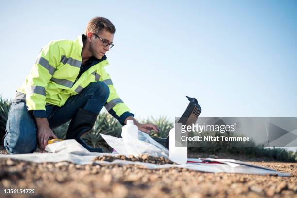 data collection features for soil sampling. biologists typing data from micro-biometer testing kit into a laptop for determining soil health and fertility. soil biology and biochemistry. - soil sample stock pictures, royalty-free photos & images