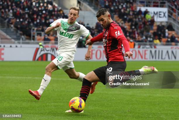 Theo Hernandez of AC Milan is challenged by Davide Frattesi of US Sassuolo during the Serie A match between AC Milan and US Sassuolo at Stadio...