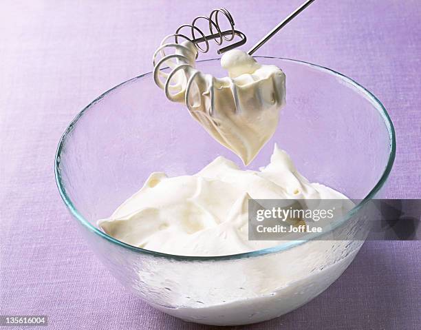 whipped cream in glass bowl with whisk - slagroom stockfoto's en -beelden