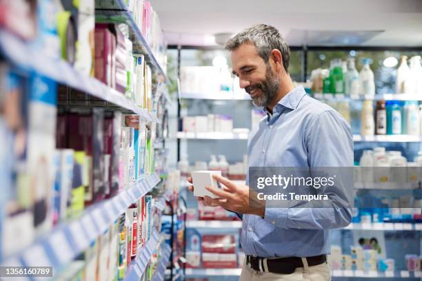 a client is buying medicines in a pharmacy. - pharmacy shopper stock pictures, royalty-free photos & images