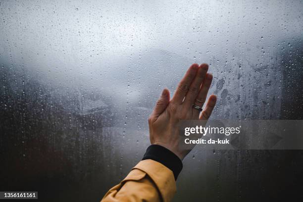 wiping the misted window - condensation stock pictures, royalty-free photos & images