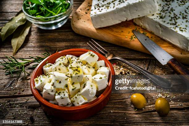 bowl with freek feta cheese cubes on rustic table - cheese cubes stock pictures, royalty-free photos & images