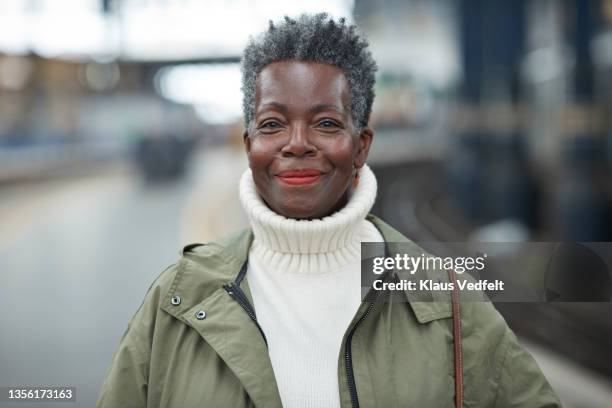 smiling senior woman at station - mock turtleneck fotografías e imágenes de stock