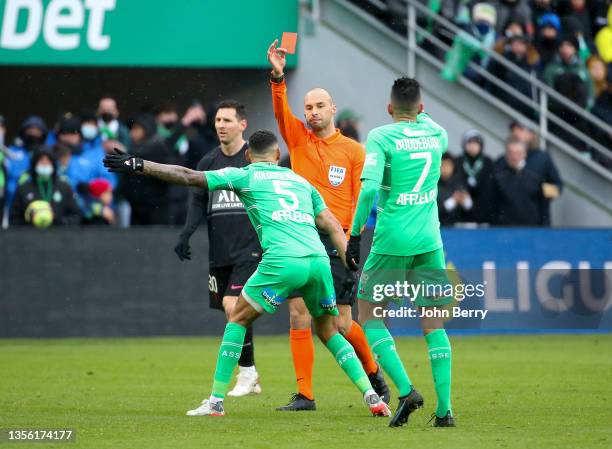 Referee Jerome Brisard gives a red card to Timothee Kolodziejczak of Saint-Etienne during the Ligue 1 Uber Eats match between AS Saint-Etienne and...