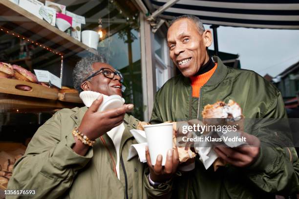 elderly woman talking with friend while having food - disposable cup stock pictures, royalty-free photos & images