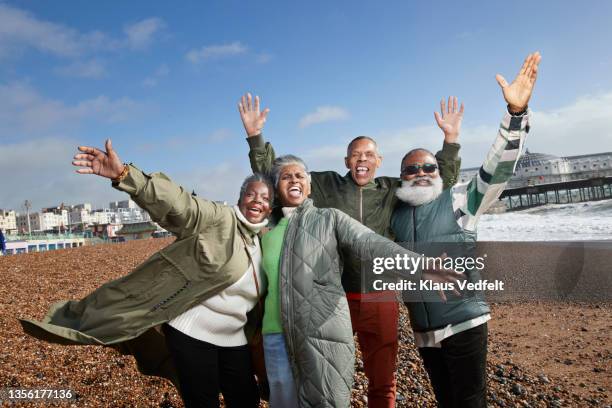 elderly men and women at beach during vacation - four day old stock pictures, royalty-free photos & images