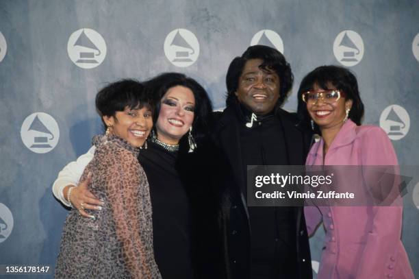 Yamma Brown, wearing a sheer leopard print coat, with Adrienne Rodriguez , American singer and musician James Brown , and Deanna Brown Thomas,...