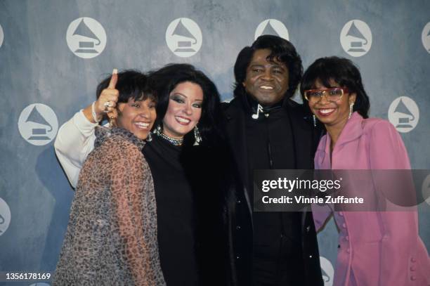 Yamma Brown, wearing a sheer leopard print coat, with Adrienne Rodriguez , American singer and musician James Brown , and Deanna Brown Thomas,...
