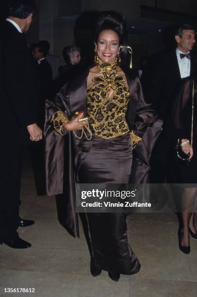 American singer and actress Freda Payne, wearing a black-and-gold outfit, attends the 9th Annual American Cinema Awards, held at the Beverly Hilton...