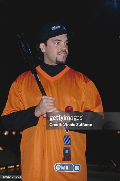 American baseball player Mike Piazza, wearing an orange-and-black sports kit, attends the recording of MTV's Ball2K, venue unspecified, in Culver...