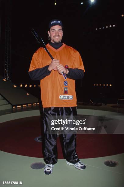 American baseball player Mike Piazza, wearing an orange-and-black sports kit, attends the recording of MTV's Ball2K, venue unspecified, in Culver...