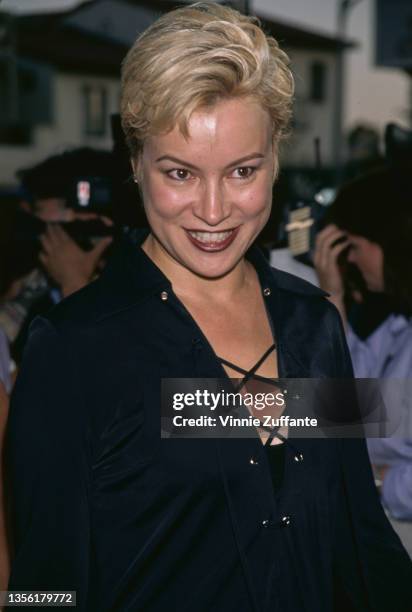 American-Canadian actress Jennifer Tilly, wearing a black suit with a long black skirt and a lace-up jacket, attends the Westwood premiere of 'Tin...