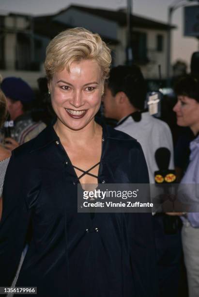 American-Canadian actress Jennifer Tilly, wearing a black suit with a long black skirt and a lace-up jacket, attends the Westwood premiere of 'Tin...