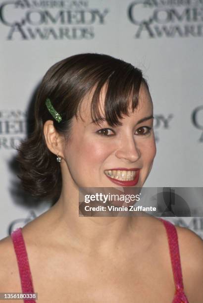 American-Canadian actress Jennifer Tilly, wearing a pink-and-orange velvet minidress, attends the 9th American Comedy Awards, held at the Shrine...