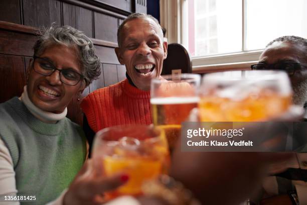 cheerful senior people toasting drink glasses - 4 cocktails stock pictures, royalty-free photos & images