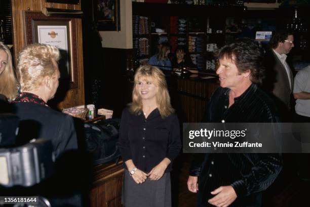 American singer, songwriter and guitarist Brian Setzer , Julie Kramer and her husband, American singer, songwriter and musician John Fogerty attend...