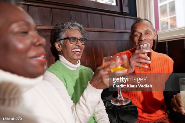 Senior friends having alcohol in bar
