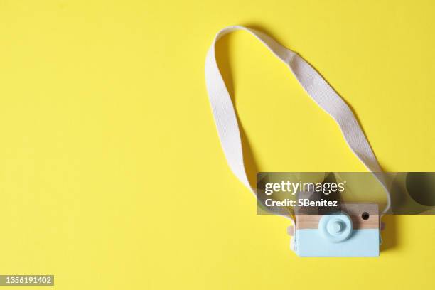 a wooden photo camera on a yellow background - toy camera stock pictures, royalty-free photos & images