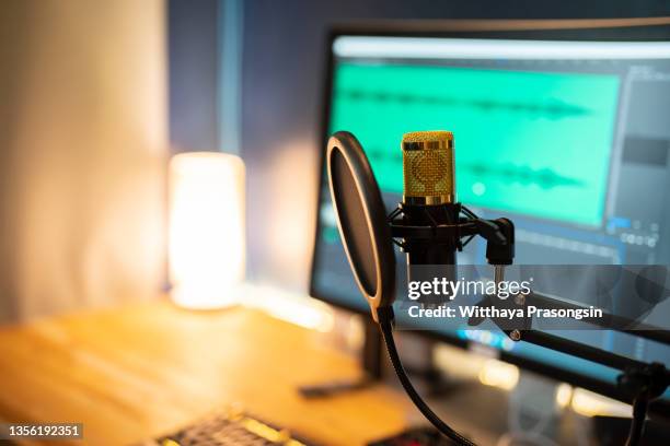 microphone on the background of the computer monitor. - podcasting mic stock pictures, royalty-free photos & images