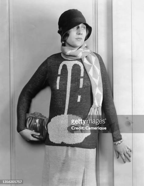 Latest fall fashions for milady.. A sport sweater "The Fountain and Fish" a new note in knitted sportswear, charteuse white buttercup. Circa 1928