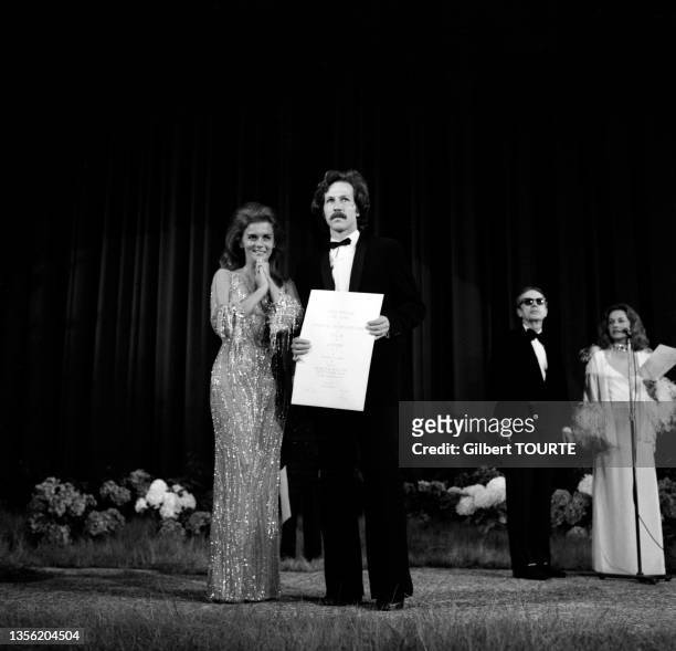 Ann-Margret and Werner Herzog on stage during the awards ceremony at the Cannes Film Festival, Cannes, France, 23rd May 1975. Herzog is holding his...
