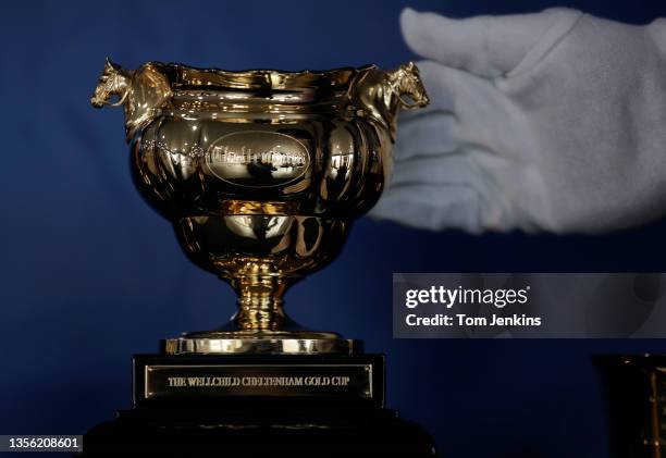 The Gold Cup gets a final polishing during day four of the Cheltenham National Hunt Racing Festival at Cheltenham Racecourse on March 19th 2021 in...
