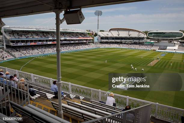 Members watch from the pavilion towards the new Compton and Edrich Stands either side of the media centre during day one of the England v New Zealand...