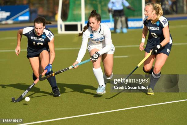 Katie George of the Middlebury Panthers handles the ball from Grace Nockolds of the Johns Hopkins Blue Jays during the Division III Women’s Field...