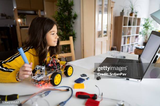 smart girl, making a prototype of an autonomous self-driven robotic car with sensors - school science project stock pictures, royalty-free photos & images